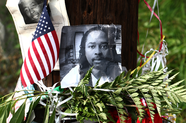 Photos of Samuel DuBose hang on a pole at a memorial, Wednesday July 29, 2015 in Cincinnati, near where he was shot and killed by a University of Cincinnati police officer. (AP/Tom Uhlman)