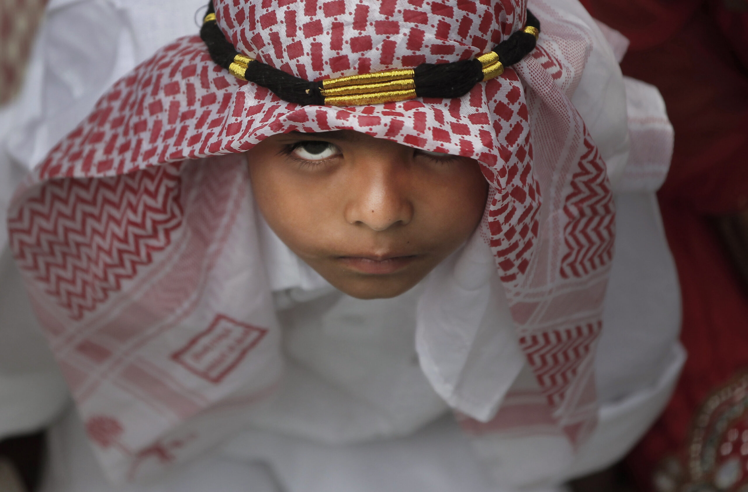 A Nepalese Muslim boy reacts to the camera as he waits to offer prayers on Eid al-Fitr at a mosque in Kathmandu, Nepal, Saturday, July 18, 2015. Millions of Muslims across the world are celebrating the Eid al-Fitr holiday, which marks the end of the month-long fast of Ramadan. (AP Photo/Niranjan Shrestha) (Niranjan Shrestha)