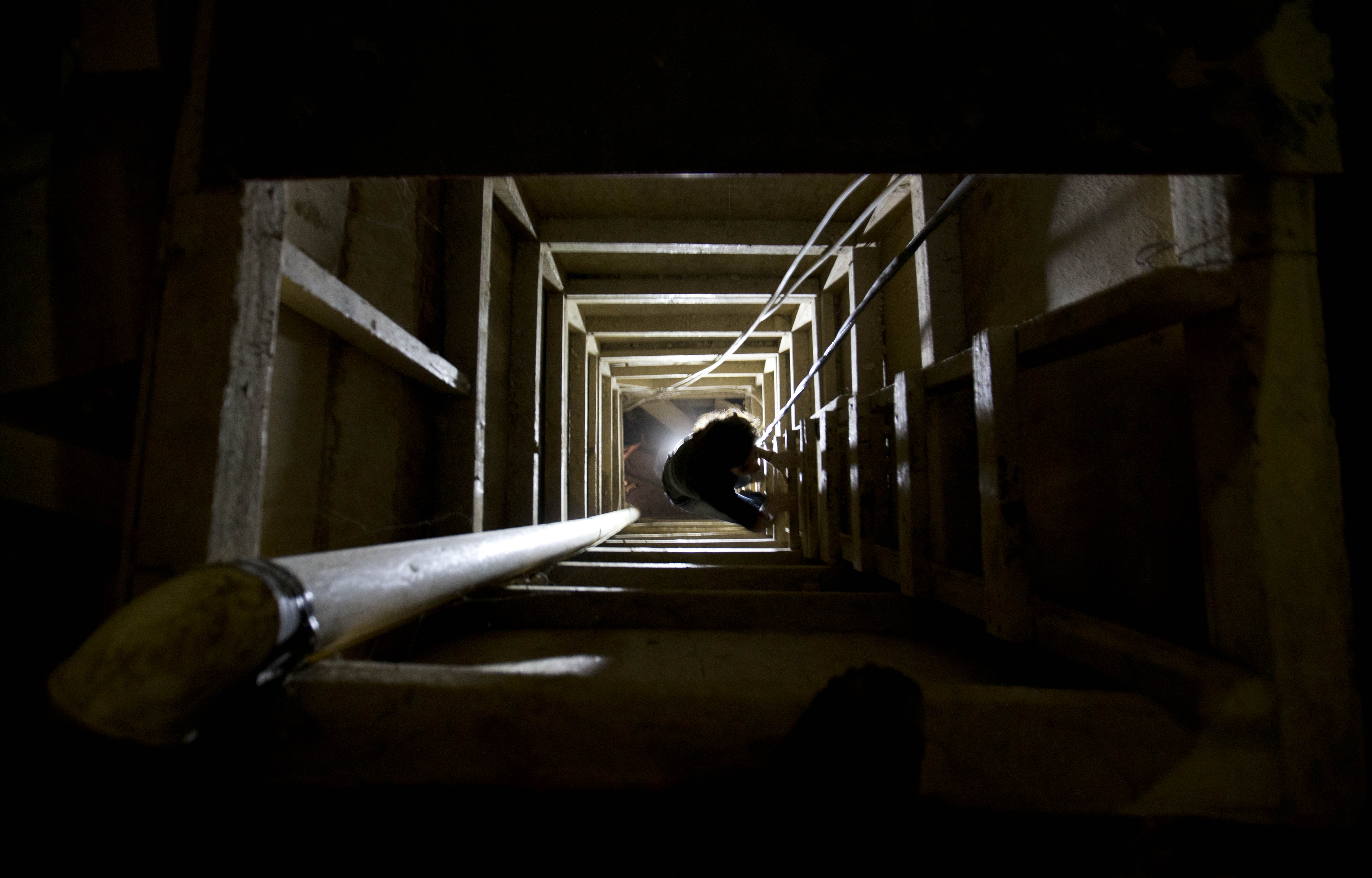 In this Tuesday, July 14, 2015 photo, a journalist climbs a ladder to get out of the tunnel that according to authorities, drug lord Joaquin "El Chapo" Guzman used to escape from the Altiplano maximum security prison in Almoloya, west of Mexico City. (AP Photo/Eduardo Verdugo) (AP)