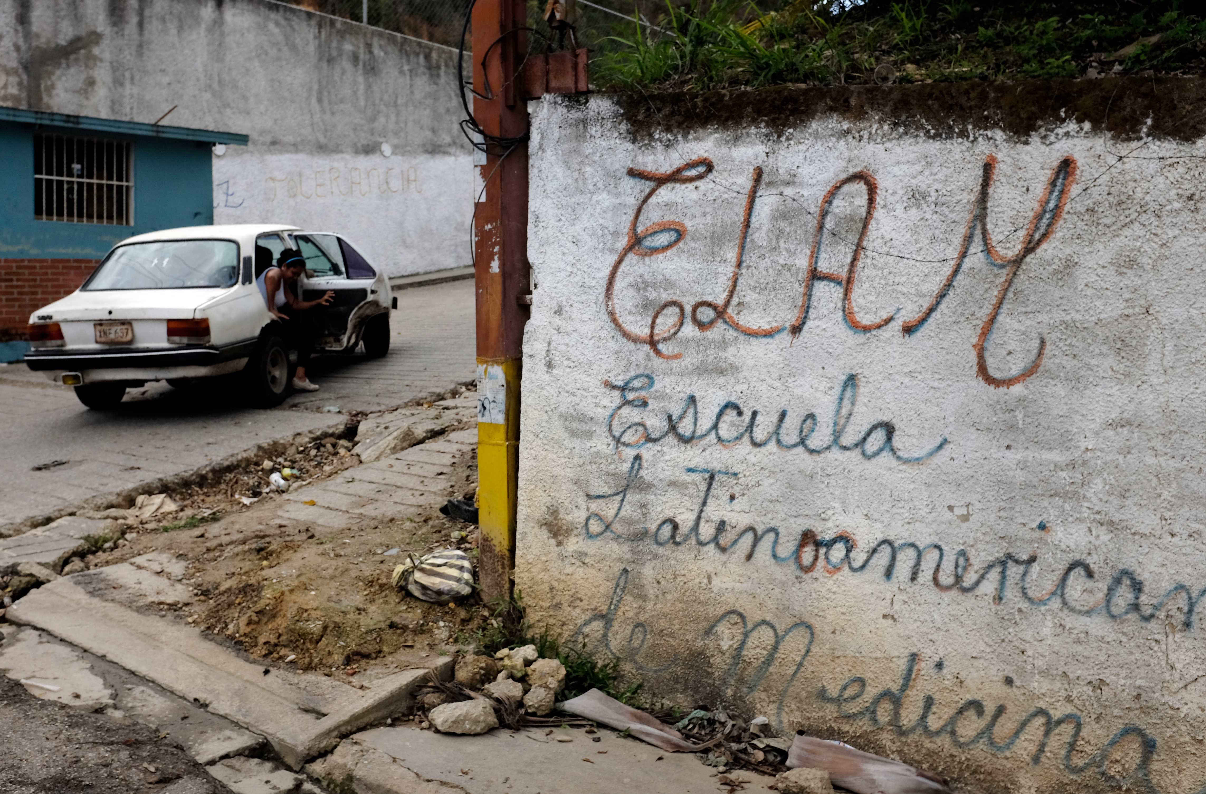 In this June 23, 2015 photo, a woman gets out from a car next to the Latin America Academy of Medicine, outside of Caracas, Venezuela. A third of the group of young Palestinians who arrived in Caracas for a program to be trained as doctors have dropped out, complaining that the program lacks academic rigor, according to interviews conducted with students, teachers and government officials. The Palestinians who left the Yasser Arafat Scholarship Program, which included seven years of room and board at a state-run school staffed by Cuban doctors, said they werent getting the training they needed to become recognized physicians. (AP Photo/Fernando Llano) (AP)