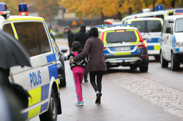 A student and her parent leave a school in Trollhattan, Sweden after a masked man killed one teacher and wounded another as well as two boys, October 22, 2015. (Reuters/Scanpix Sweden)