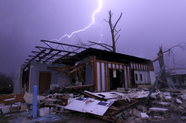 Lightning illuminates a house after a tornado touched down in Jefferson County, Ala., Friday, Dec. 25, 2015. (AP/Butch Dill)