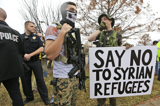 Armed anti-Muslim protestors stand across the street from a mosque during a demonstration in Richardson, Texas, Dec. 12, 2015. (AP/LM Otero)