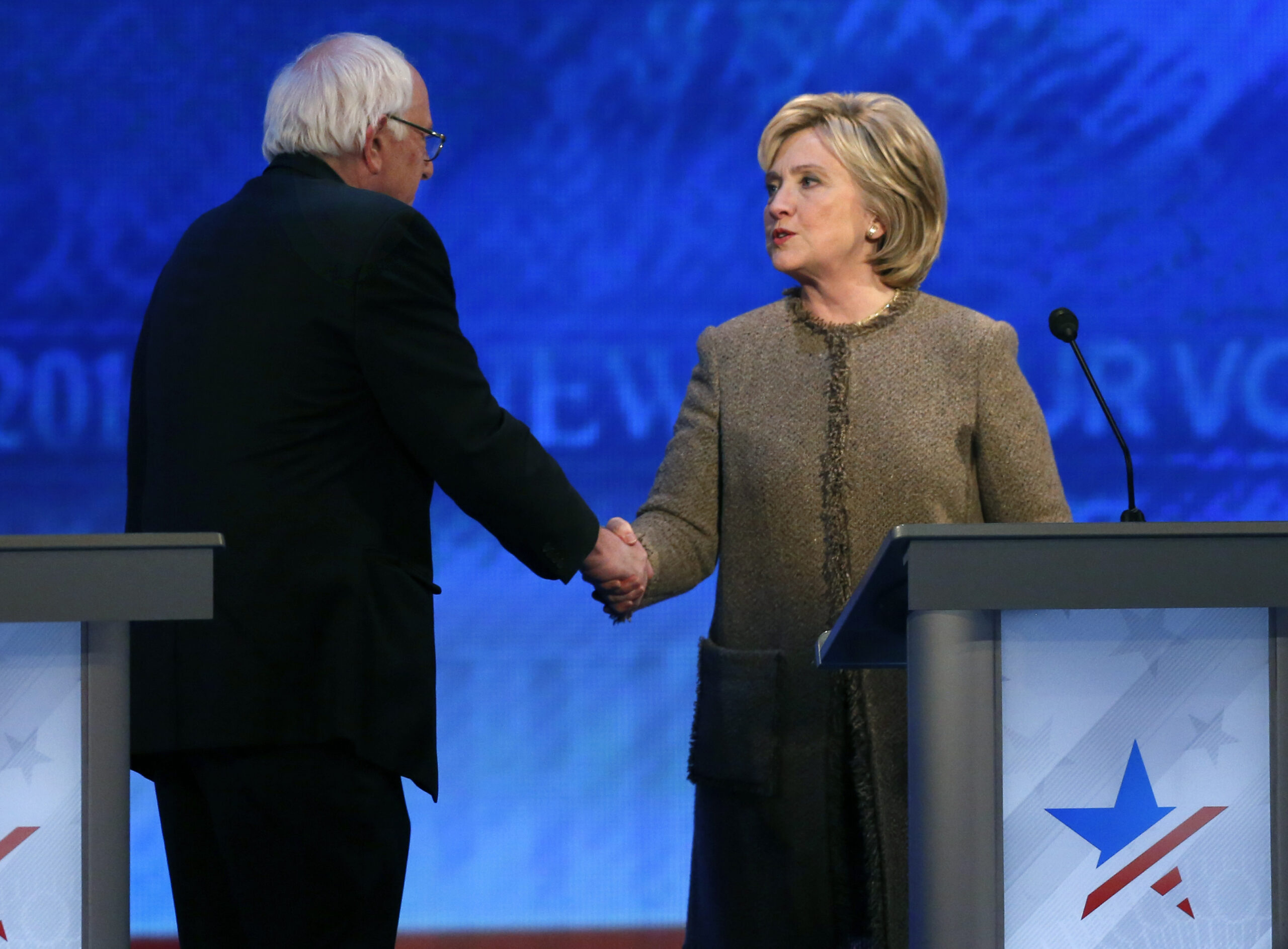 Bernie Sanders, left, speaks to Hillary Clinton after a Democratic presidential primary debate Saturday, Dec. 19, 2015, at Saint Anselm College in Manchester, N.H. (AP Photo/Jim Cole) (AP)