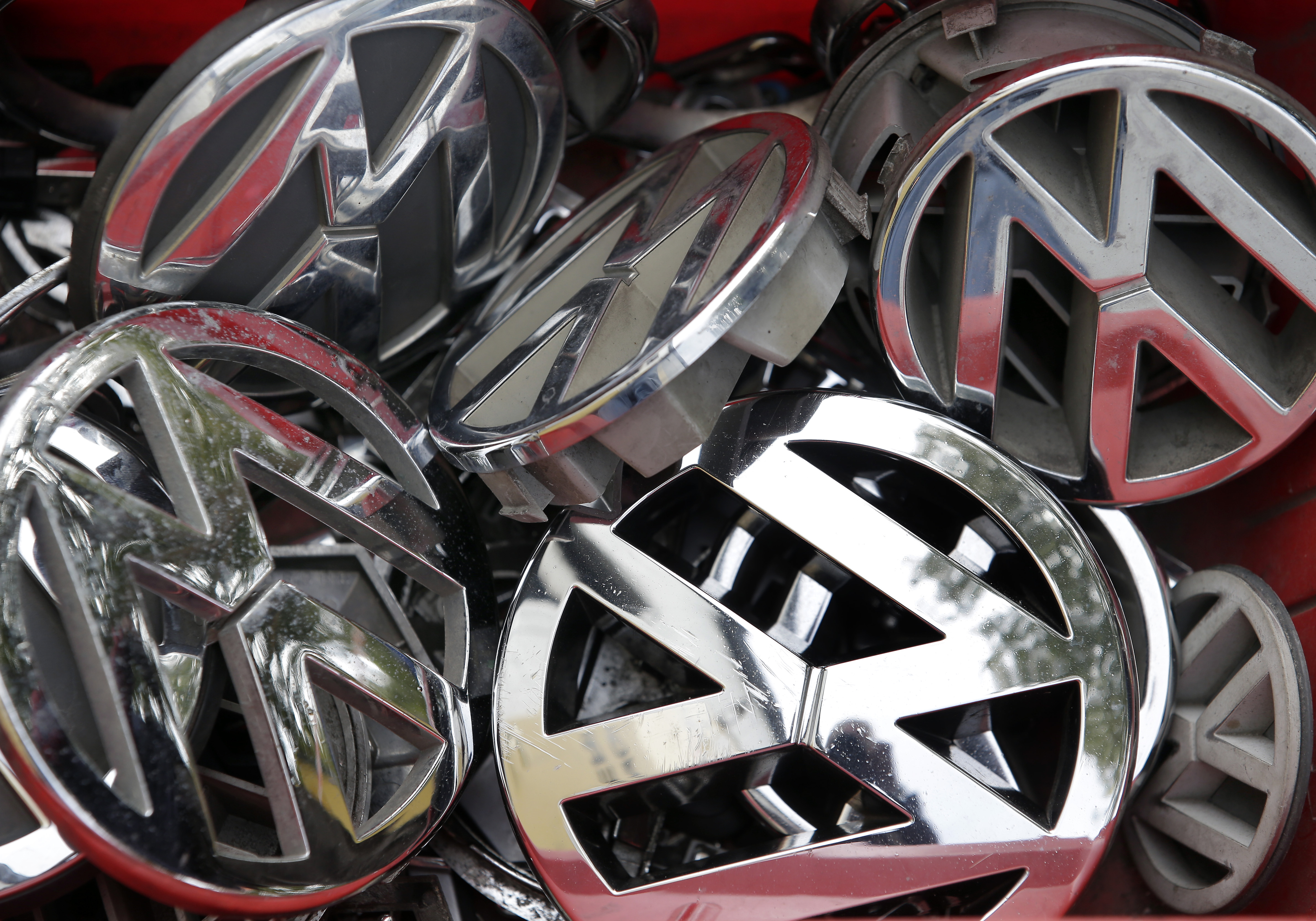 FILE - In this Sept. 23, 2015 file photo Volkswagen ornaments sit in a box in a scrap yard in Berlin, Germany. Volkswagen said Wednesday, Dec. 9, 2015 that a problem with carbon dioxide emissions is far smaller than initially suspected, with further checks finding "slight discrepancies" in only a few models and no evidence of illegal changes to fuel consumption and emissions figures. (AP Photo/Michael Sohn, file) (AP)