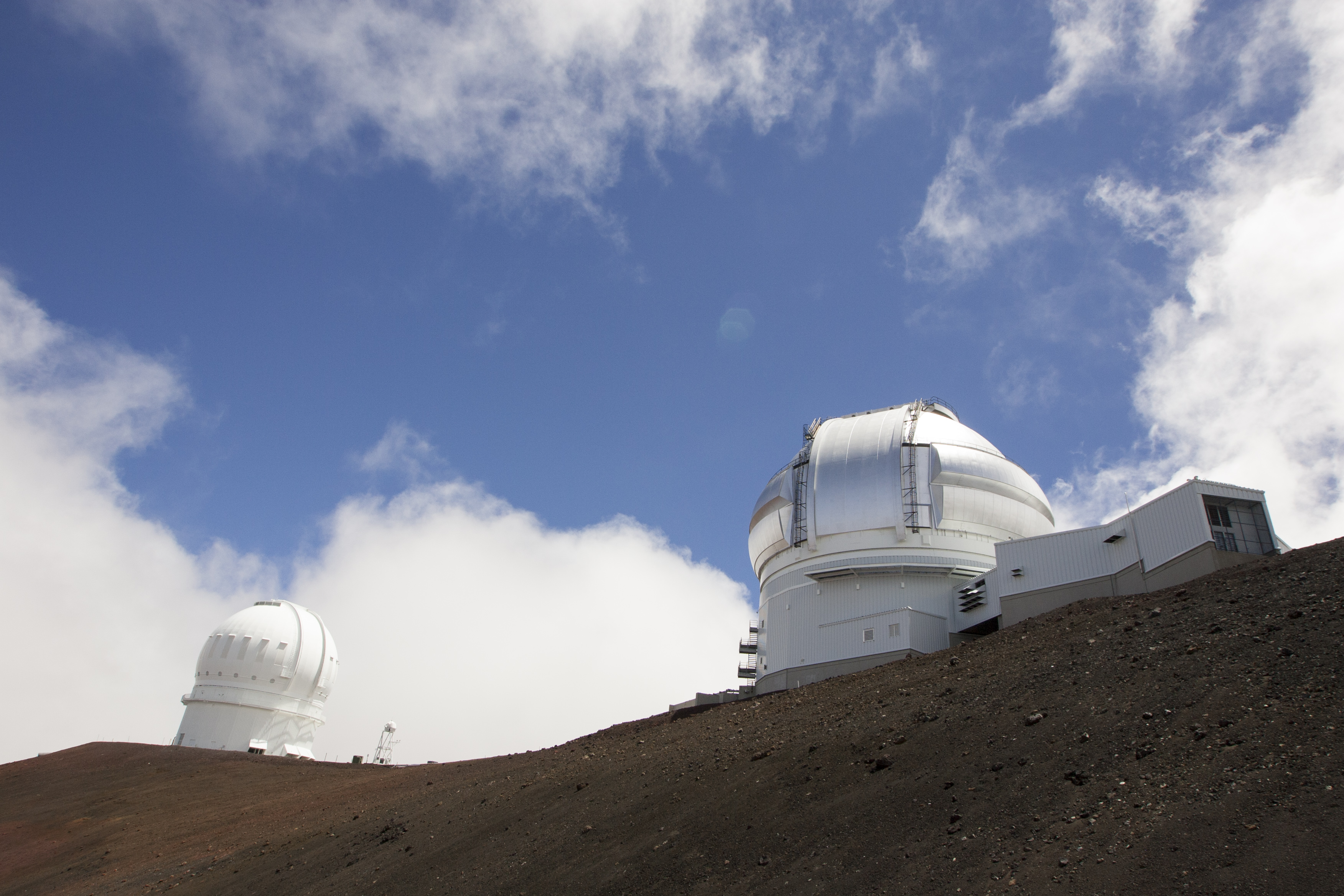 FILE-This Aug. 31, 2015, file photo shows the Gemini Telescope, right, and Canada-France-Hawaii Telescope on Hawaiis Mauna Kea near Hilo, Hawaii. (AP Photo/Caleb Jones, File)