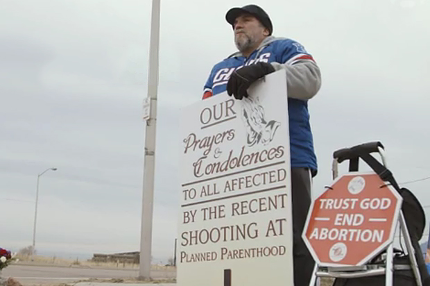 Anti-abortion protester Joseph Martone stands outside Planned Parenthood, Colorado Springs, Co. (theguardian.com)