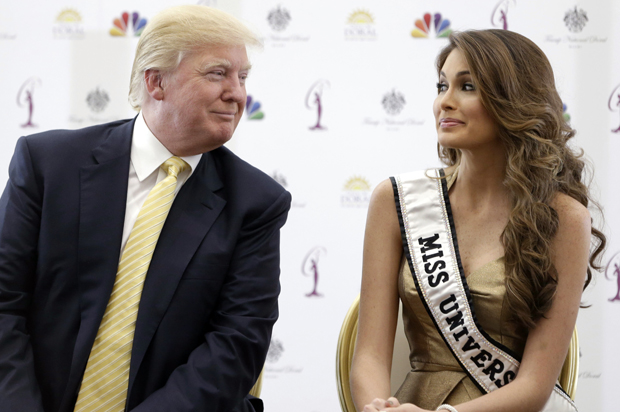 Donald Trump and Miss Universe, Gabriela Isler, of Venezuela, talk during a news conference, Thursday, Oct. 2, 2014, in Doral, Fla. (AP/Wilfredo Lee)