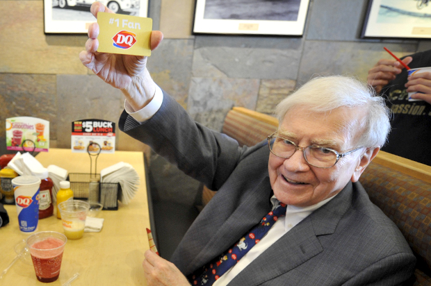Warren Buffett holds a Dairy Queen gold gift card, Monday May 20, 2013 in Omaha, Neb. (AP/Dave Weaver)