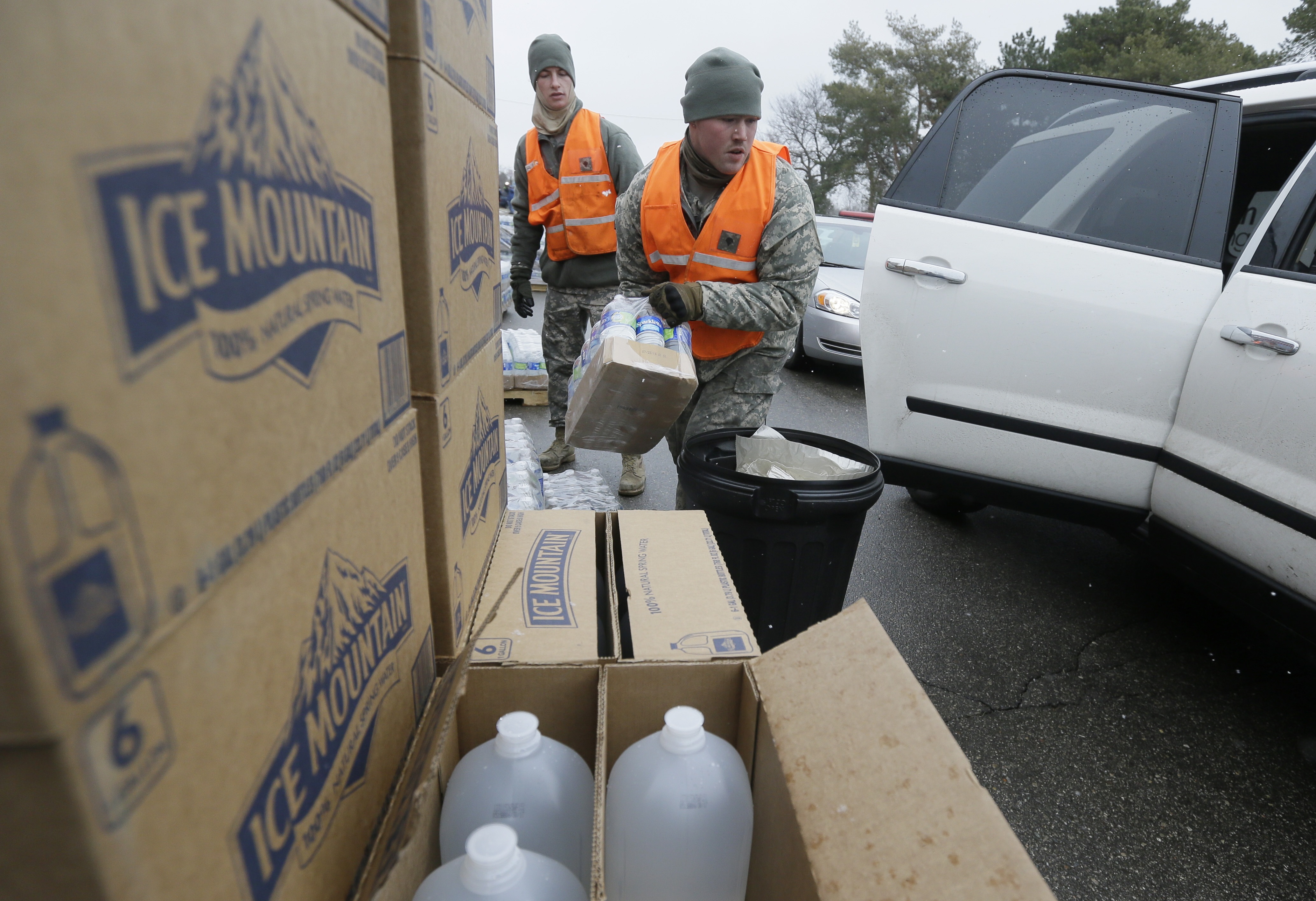 Members of the Michigan National Guard load bottled water at a fire station, Thursday, Jan. 28, 2016 in Flint, Mich. The Michigan Legislature voted Thursday to direct another $28 million to address Flint's water emergency, allocating money for bottled water, medical assessments and other costs in the city struggling with a lead-contaminated supply. (AP Photo/Carlos Osorio) (AP)