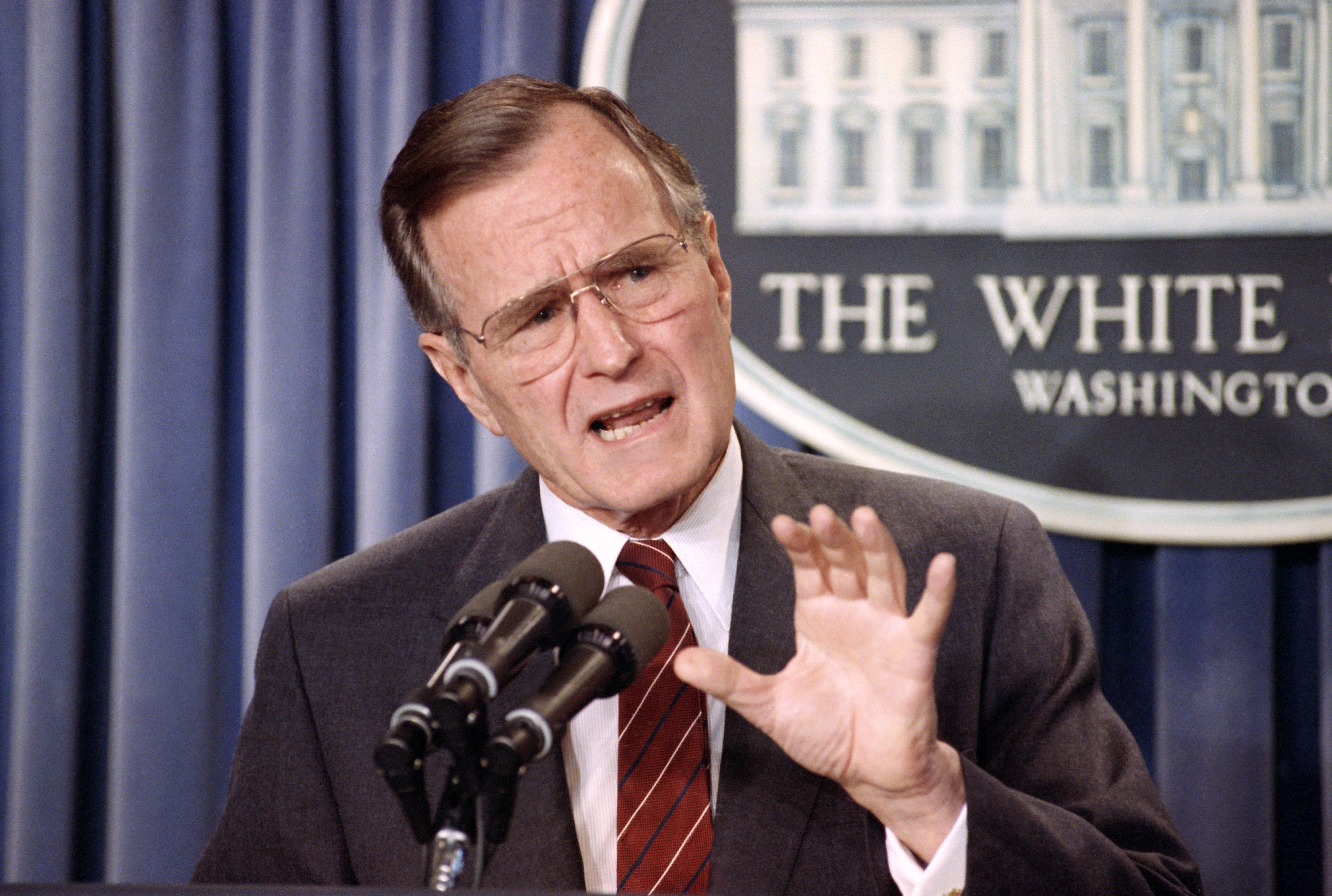 FILE - In this March 13, 1990 file photo, President George H.W. Bush speaks during a news conference in the White House briefing room in Washington. Ted Cruz once proudly wore a belt buckle reading President of the United States borrowed from George H.W. Bush. He campaigned and worked for, and helped write a book lavishing praise on, that former presidents son, Dubya. And the endorsement of George P. Bush, the familys latest rising political star, lent credibility to Cruzs then little-known 2012 Senate campaign. (AP Photo/Barry Thumma, File) (AP)
