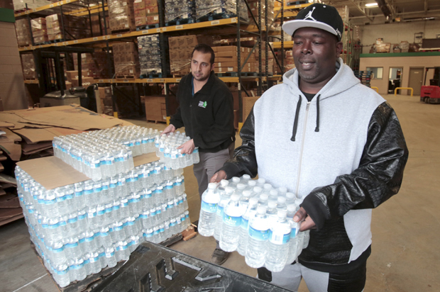 Bottled water is picked up from the Food Bank of Eastern Michigan to deliver to a school after elevated lead levels were found in the city's water in Flint, Michigan December 16, 2015. (Reuters/Rebecca Cook)