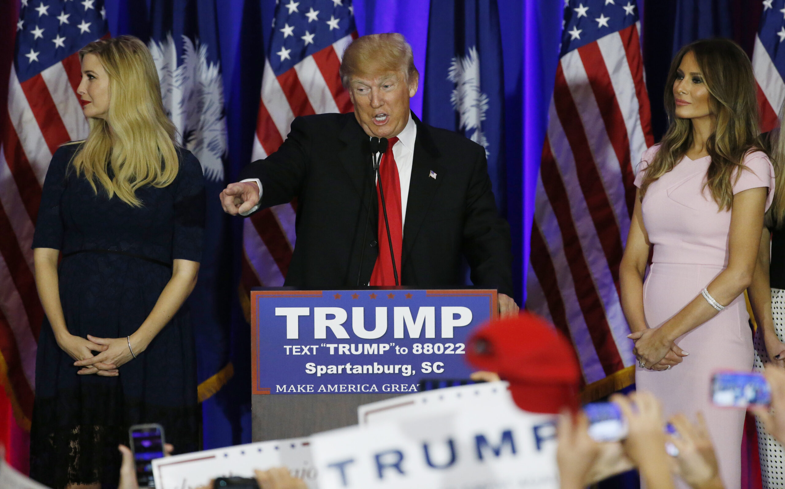 Republican U.S. presidential candidate Donald Trump points into the crowd while accompanied by his daughter Ivanka (L) and his wife Melania (R) at his 2016 South Carolina presidential primary night victory rally in Spartanburg, South Carolina February 20, 2016. REUTERS/Jonathan Ernst  - RTX27V8Q (Reuters)