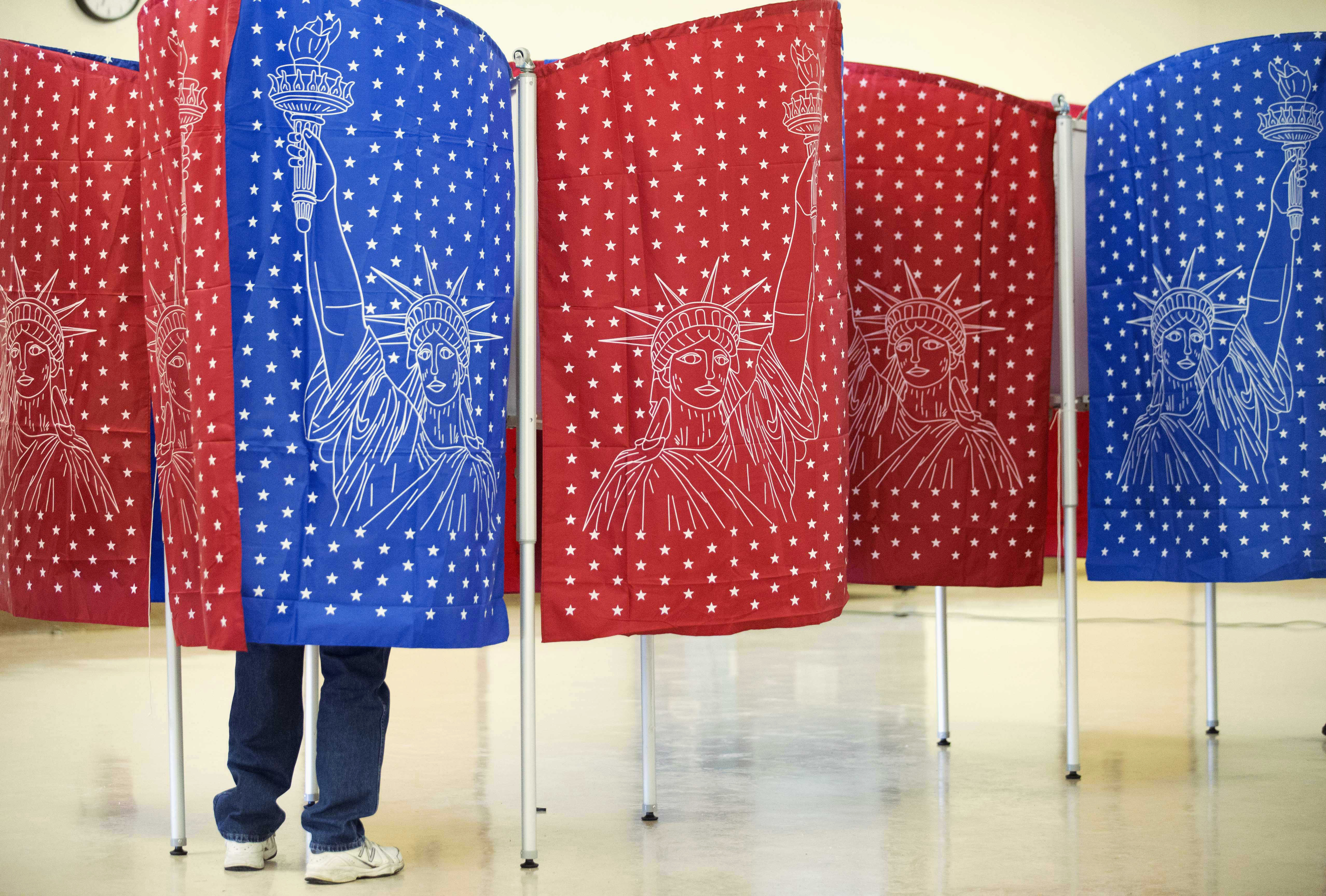 A voter marks a ballot for the New Hampshire primary inside a voting booth at a polling place Tuesday, Feb. 9, 2016, in Manchester, N.H. (AP Photo/David Goldman) (AP)