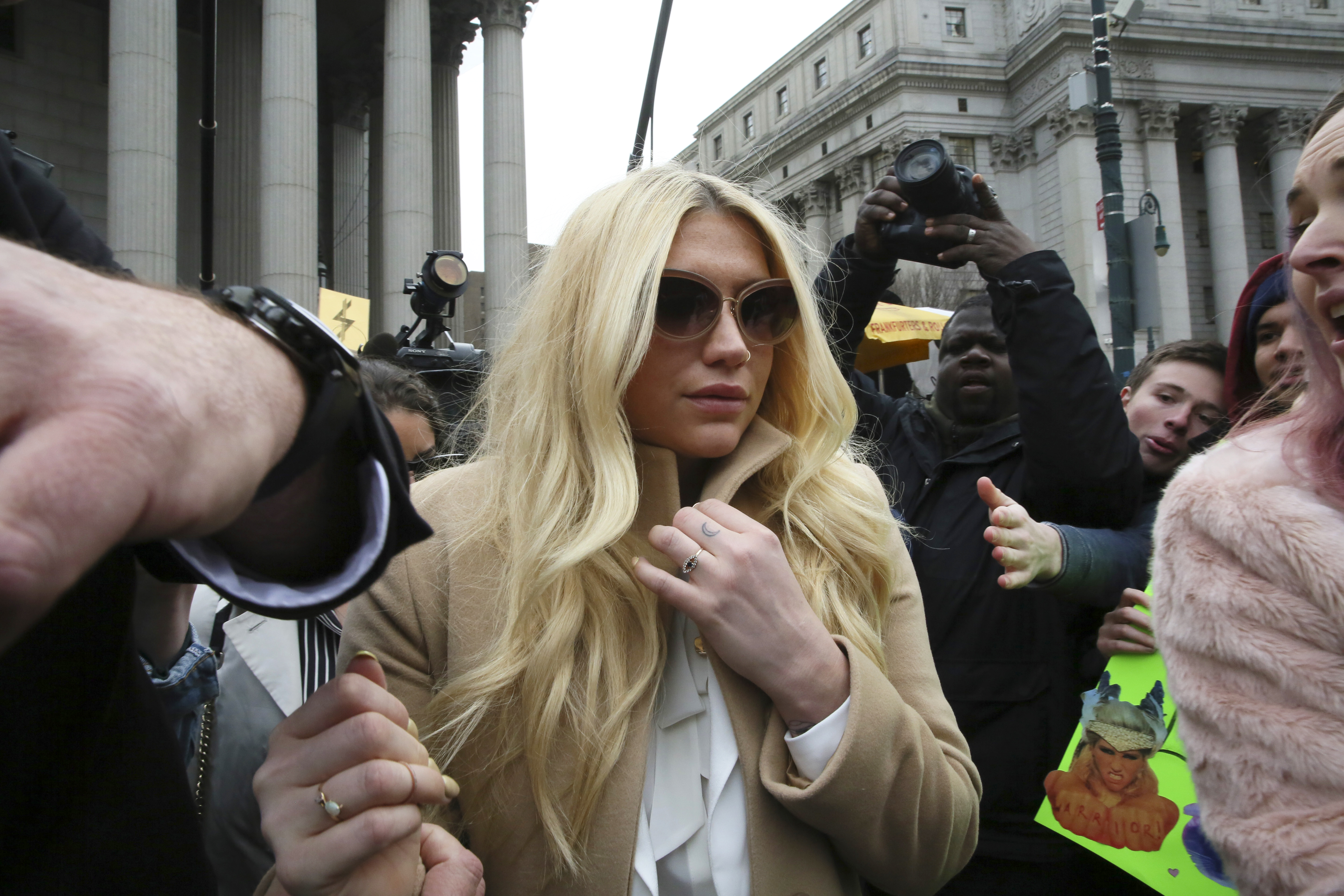 Pop star Kesha leaves Supreme court in New York, Friday, Feb. 19, 2016. Kesha is fighting to wrest her career away from a hitmaker she says drugged, sexually abused and psychologically tormented her _ and still has exclusive rights to make records with her. Producer Dr. Luke says the singer is slinging falsehoods and ruining his reputation to try to weasel out of her recording contract and strike a new deal. ((AP Photo/Mary Altaffer))
