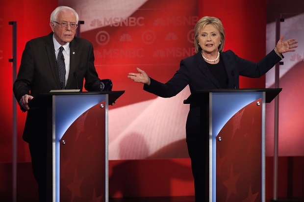Democratic U.S. presidential candidate and U.S. Senator Bernie Sanders (L) listens as former Secretary of State Hillary Clinton speaks during the Democratic presidential candidates debate sponsored by MSNBC at the University of New Hampshire in Durham, New Hampshire, February 4, 2016. REUTERS/Mike Segar - RTX25IVB (Reuters)