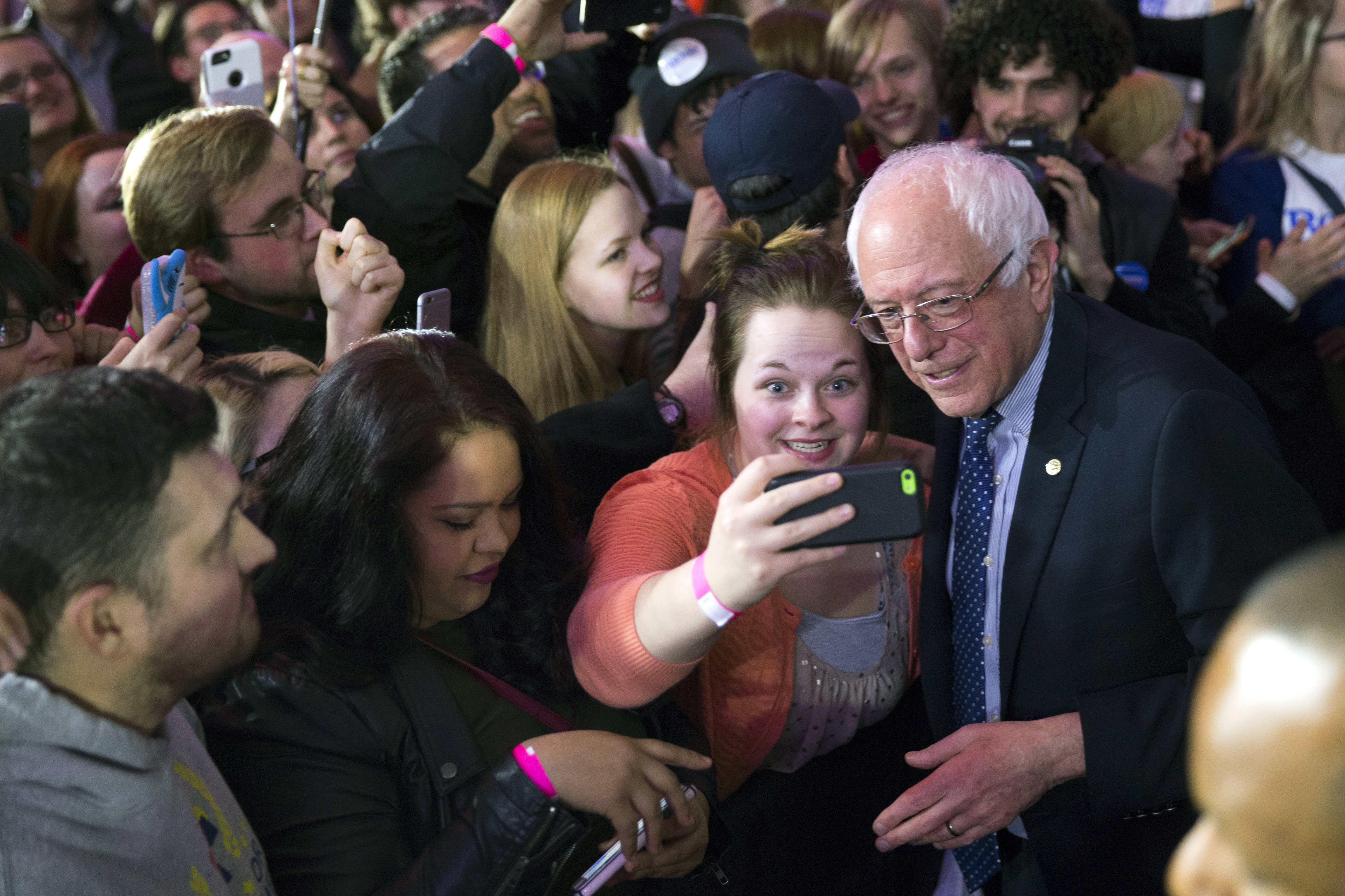 Democratic presidential candidate Sen. Bernie Sanders, I-Vt., poses for photos during a caucus night rally on Monday, Feb. 1, 2016, in Des Moines, Iowa. (AP Photo/Evan Vucci) (AP)