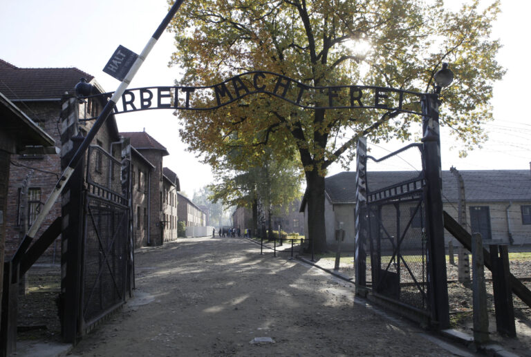 FILE - In this Oct. 19, 2012 file photo the entrance  with the inscription "Arbeit Macht Frei" (Work Sets You Free) gate of the former German Nazi death camp of Auschwitz is pictured at the Auschwitz-Birkenau memorial in Oswiecim, Poland. A 94-year-old former SS guard at the Auschwitz death camp is going on trial Thursday, Feb. 11, 2016 on 170,000 counts of accessory to murder, the first of up to four cases being brought to court this year in an 11th-hour push by German prosecutors to punish Nazi war crimes. (AP)
