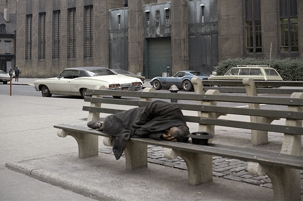 A homeless man sleeps on a bench outside the Manhattan House of Detention, also known as The Tombs, Oct. 31, 1970. (AP/Ed Ford)