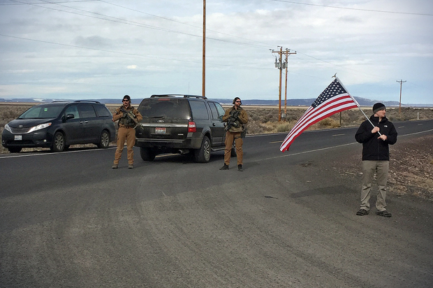 Armed law enforcement officers stand near a closed highway about 4 miles outside of the Malheur National Wildlife Refuge in Burns, Ore, after the last four occupiers of the national nature preserve surrendered on Thursday, Feb. 11, 2016. (AP/Rebecca Boone)