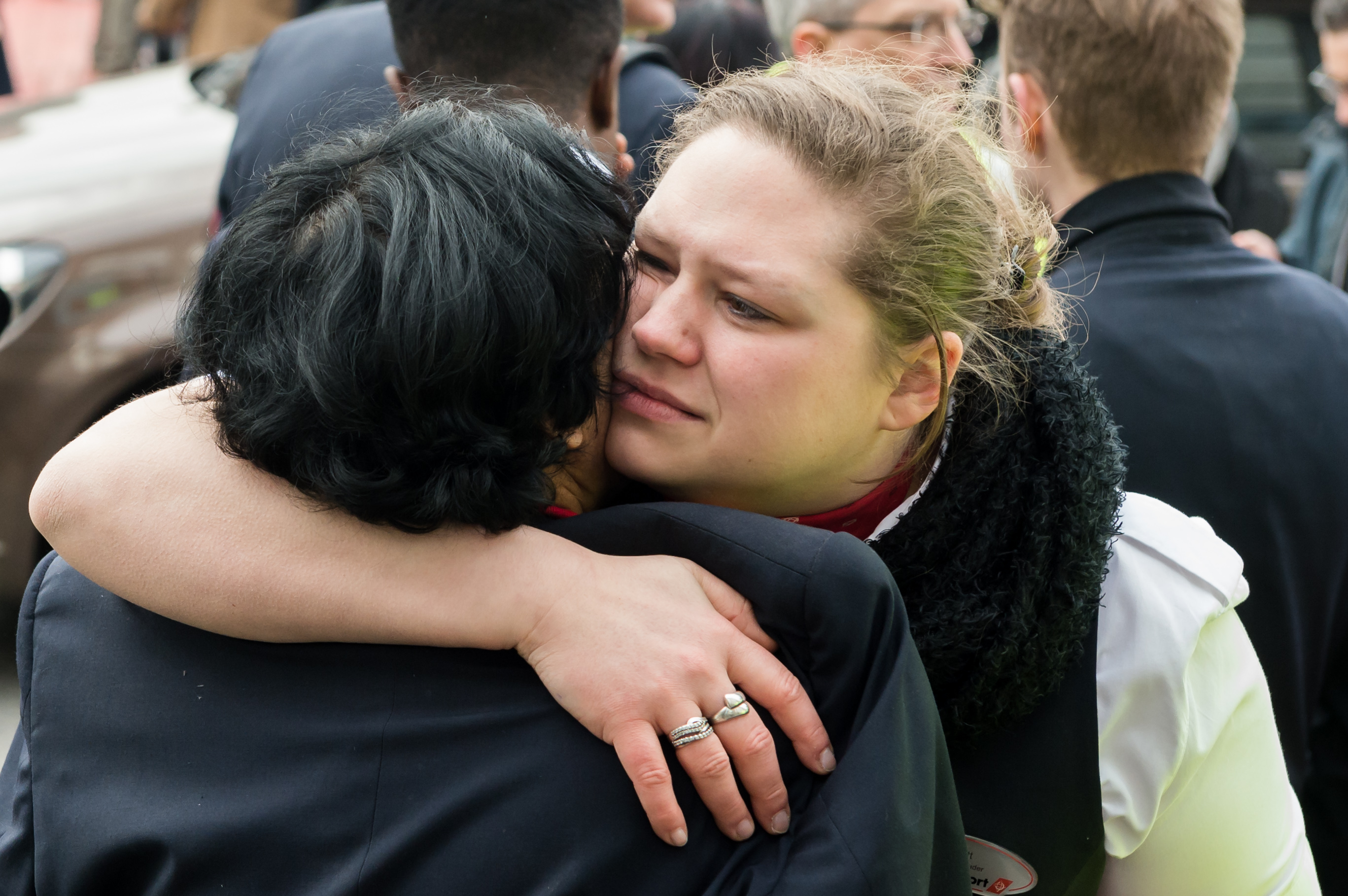 People react outside Brussels airport after explosions rocked the facility. (AP/Geert Vanden Wijngaert)