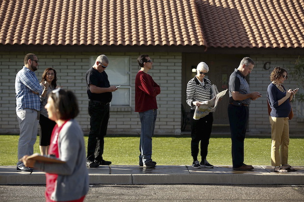 People wait to vote in the presidential primary election outside a polling site in Glendale, Arizona on March 22, 2016, after 70 percent of polling locations were cut (Reuters/Nancy Wiechec)