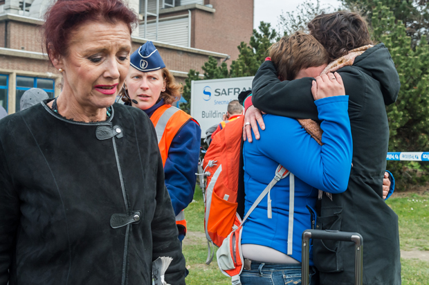 People react outside Brussels airport after explosions, March 22, 2016. (AP/Geert Vanden Wijngaert)