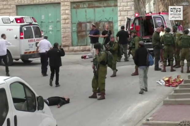 Israeli soldier points his rifle at incapacitated Palestinian man moments before extrajudicially executing him in the occupied West Bank (YouTube/B'Tselem)