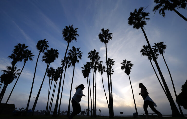 FILE - In this Feb. 23, 2016, file photo, women run as the sun sets in San Diego. Winter, especially in the southern half of the state, has been dry, and rain and snowfall in the weeks ahead would have to be extensive to make up lost ground in the state, even with the current forecast of a series of early March storms heading directly toward California. (AP Photo/Gregory Bull, File) (AP)
