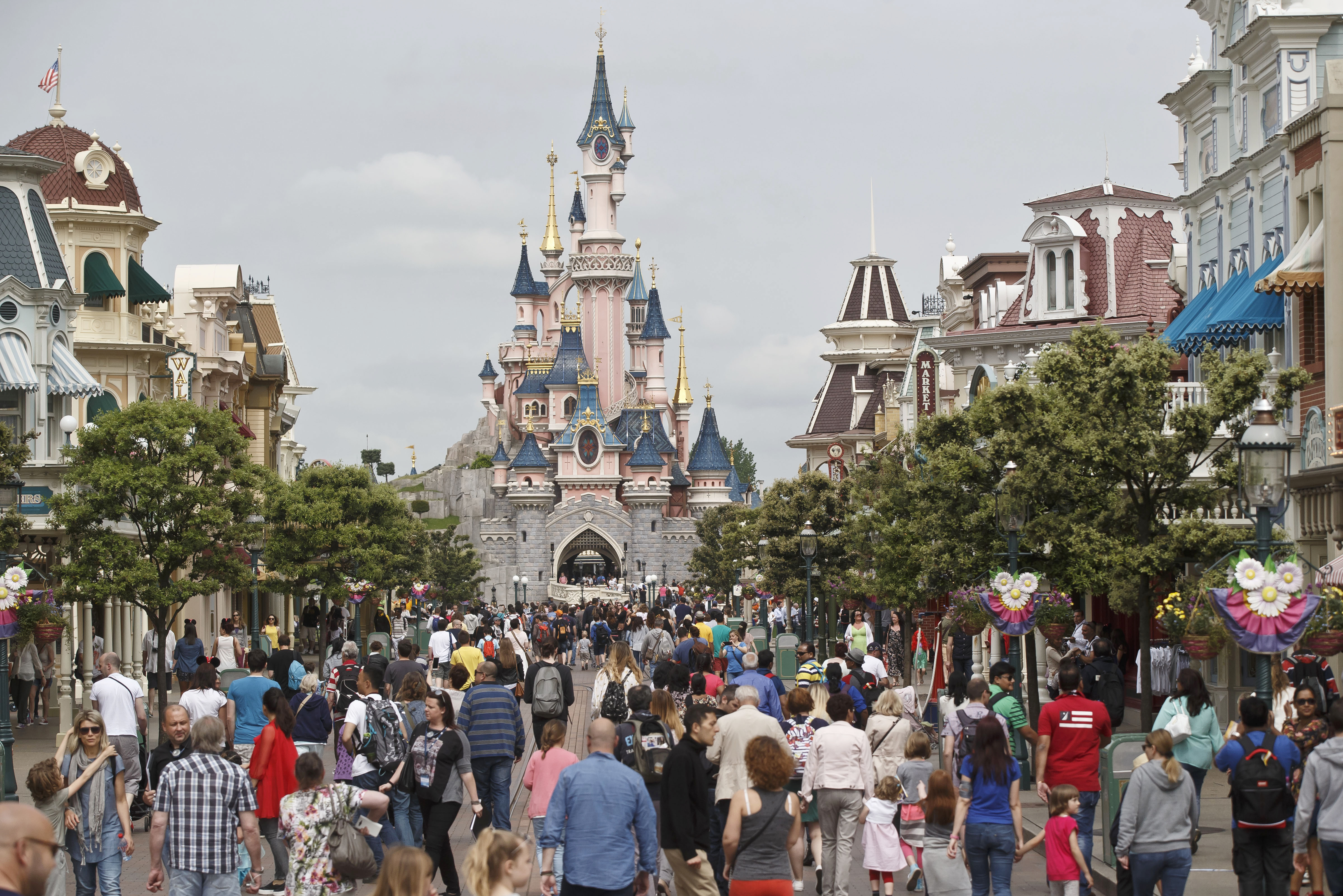 FILE - In this May 12, 2015, file photo, visitors walk near Sleeping Beauty's Castle at Disneyland Paris, in Marne la Vallee, France.(AP Photo/Michel Euler, File) (AP)