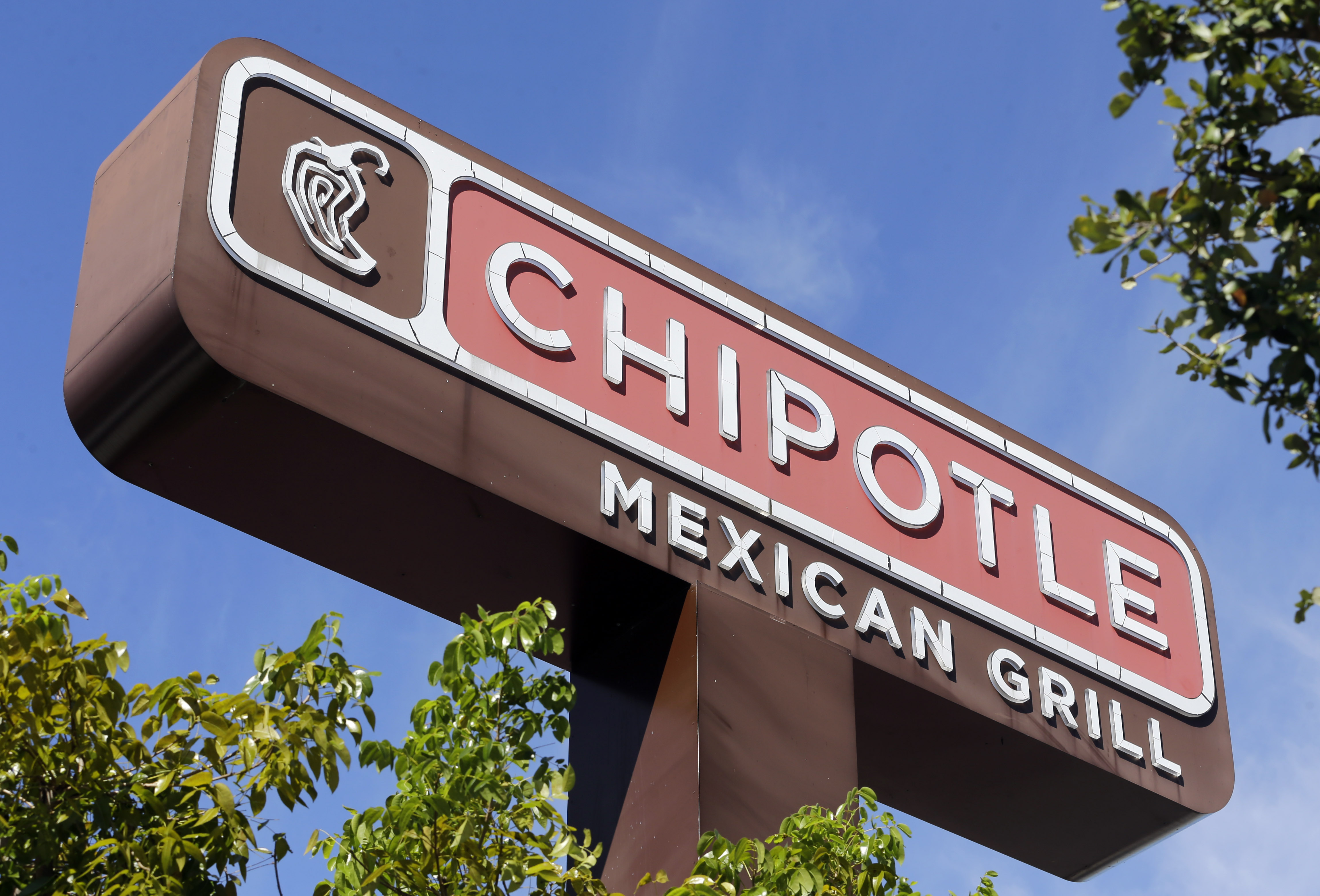 This Monday, Feb. 8, 2016, photo, shows the sign of a Chipotle restaurant in Hialeah, Fla. Chipotle is using free burrito offers to combat the eerie look of empty stores and convince people its safe to return. The offers come as Chipotle fights to recover from a series of food scares, with sales down 26 percent in February. () (AP Photo/Alan Diaz)