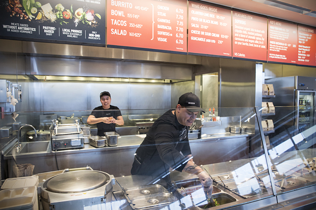 A Chipotle Mexican Grill employee prepares food, Dec. 15, 2015, in Seattle. (AP/Stephen Brashear)