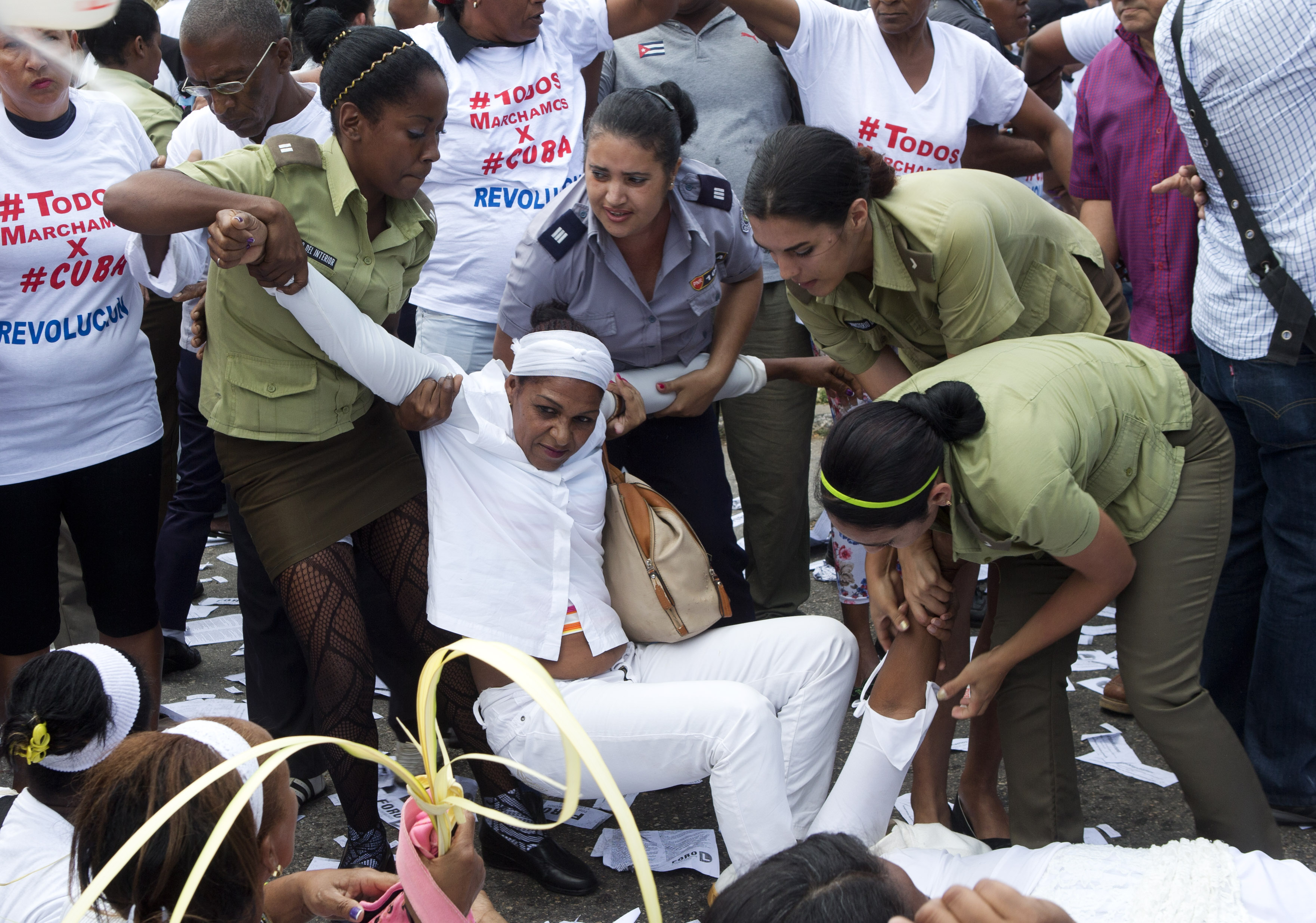 Policewomen drag away a member of Ladies in White during their weekly protest in Havana, Cuba, Sunday, March 20, 2016. (AP Photo/Rebecca Blackwell)