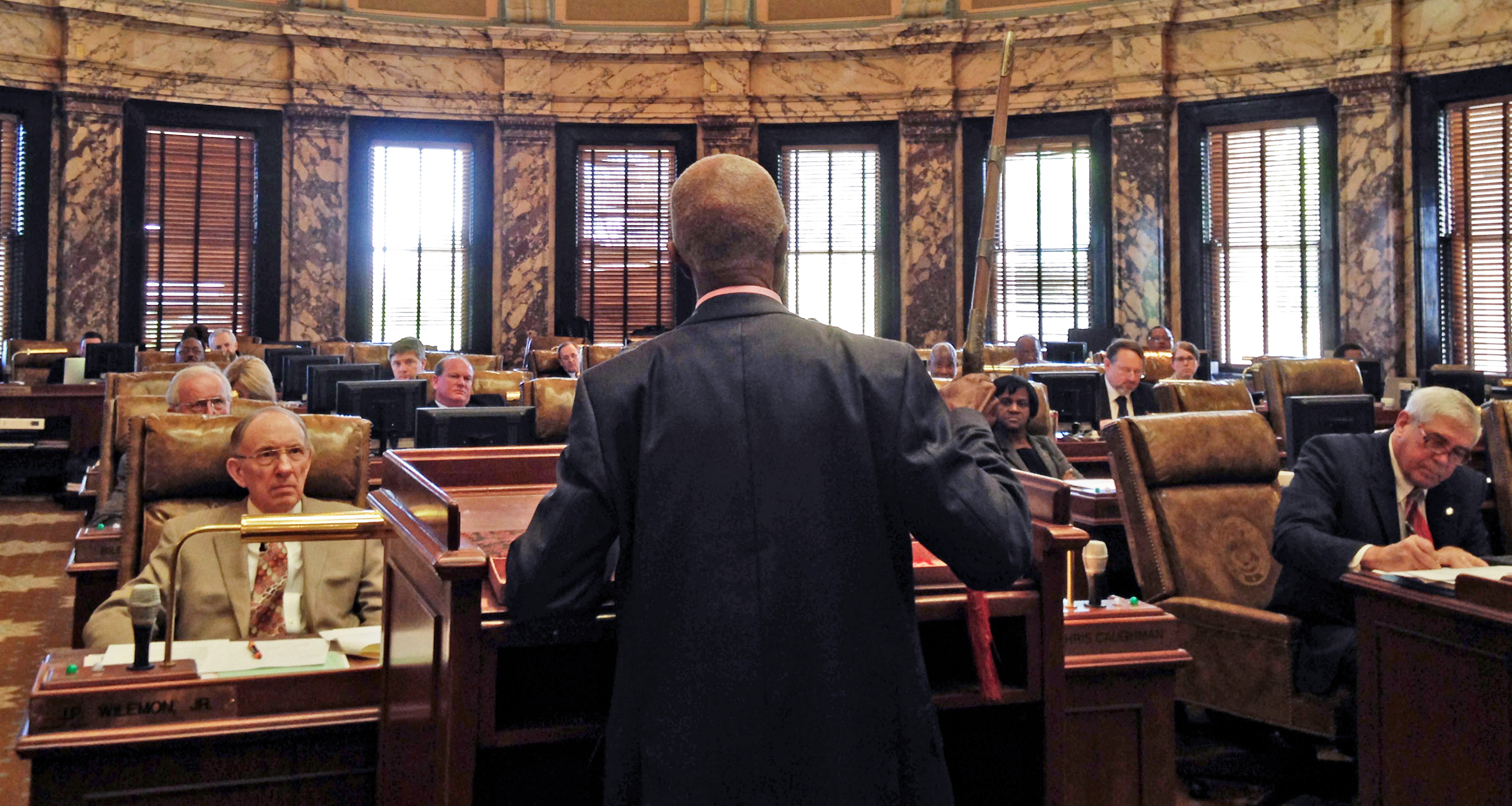 Sen. Hillman Frazier brandishes a sheathed sword Tuesday, during debate over House Bill 786, at the Capitol in Jackson, Miss. Frazier opposed the bill. (AP Photo/Jeff Amy)