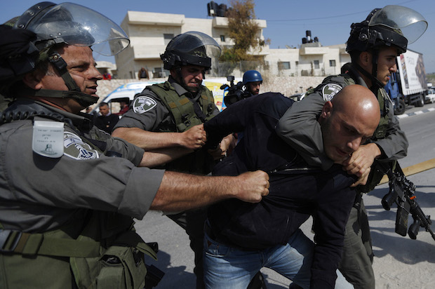Israeli police detain a Palestinian protester near the West Bank town of Abu Dis, near Jerusalem, in March 2015 (Reuters/Mohamad Torokman)