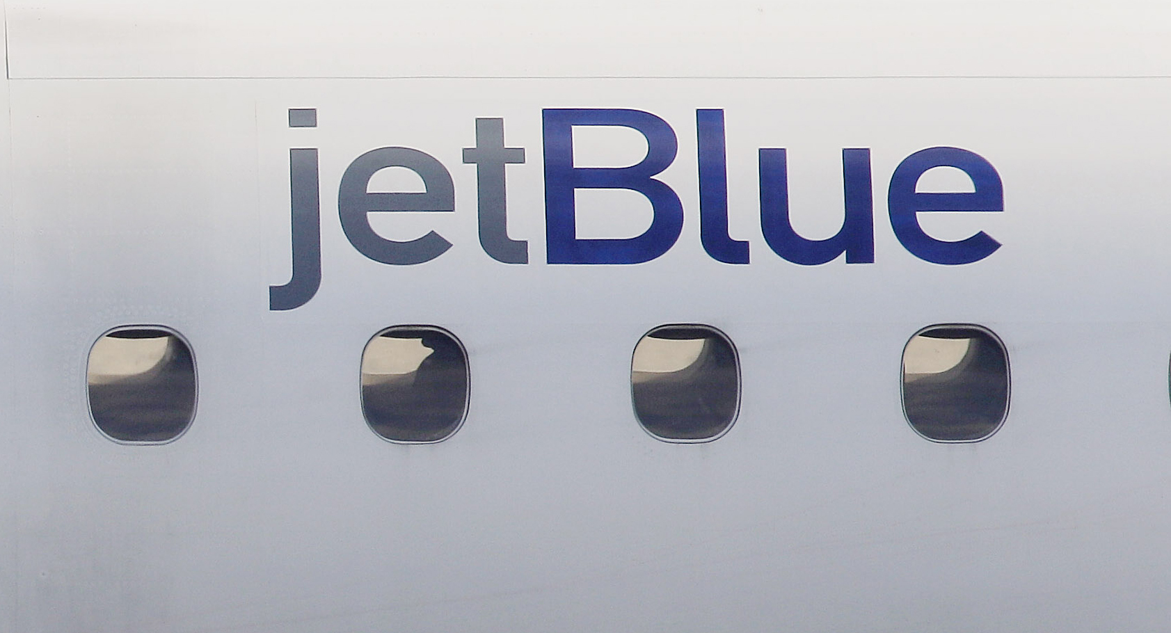 FILE - In this Jan. 20, 2011, file photo, a JetBlue logo is displayed on the side of a jet as it taxis at Boston's Logan International Airport. (AP)