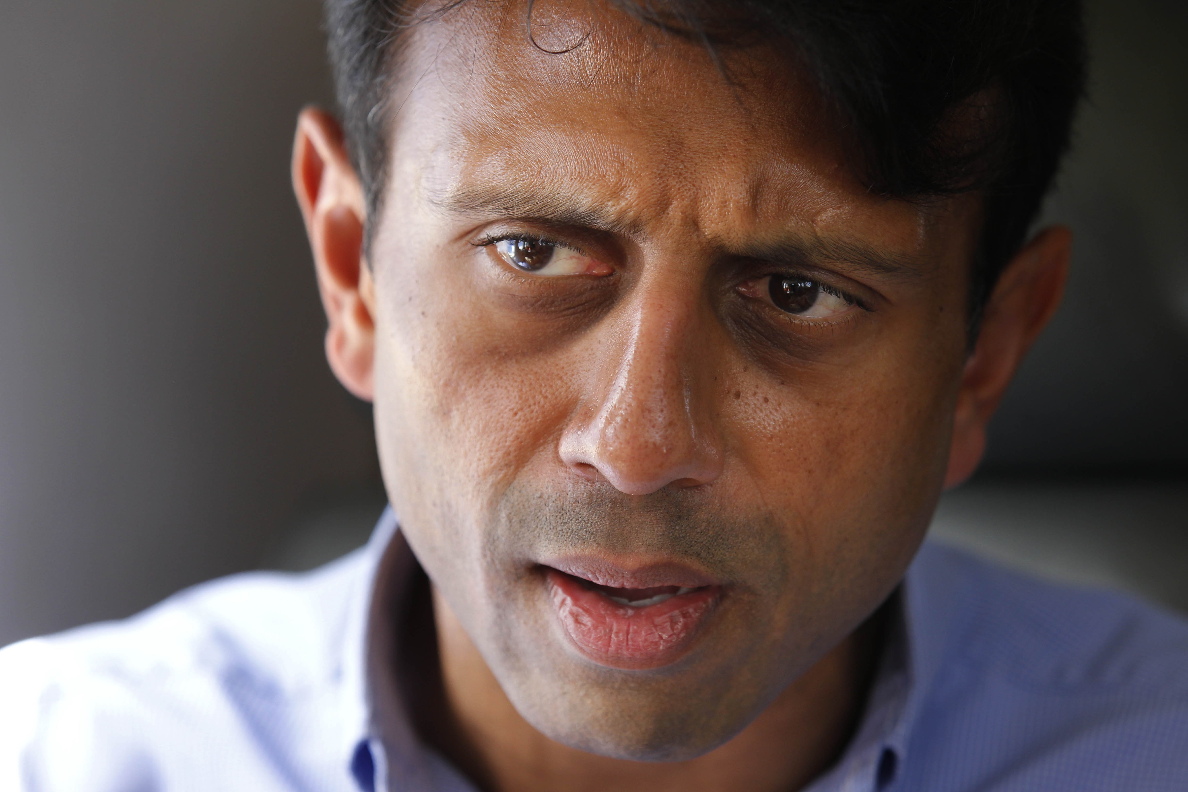 FILE - In this July 20, 2010 file photo, Louisiana Gov. Bobby Jindal talks about the oil spill as he flies over the Deepwater Horizon oil spill site in the Gulf of Mexico, off the Louisiana coast. Jindal left the governors office nearly two months ago, but his legacy permeates a special legislative session aimed at digging Louisiana out of deep financial troubles. Criticism of Jindal is bipartisan and widespread, with irritated lawmakers left sifting through the highly-unpopular choices of raising taxes or taking a hatchet to higher education and government services. (AP Photo/Gerald Herbert, File) (AP)