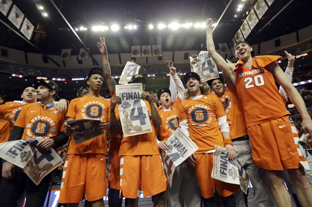 Syracuse players celebrate after beating Virginia in the regional finals of the NCAA Tournament, March 27, 2016, in Chicago. (AP/Nam Y. Huh)