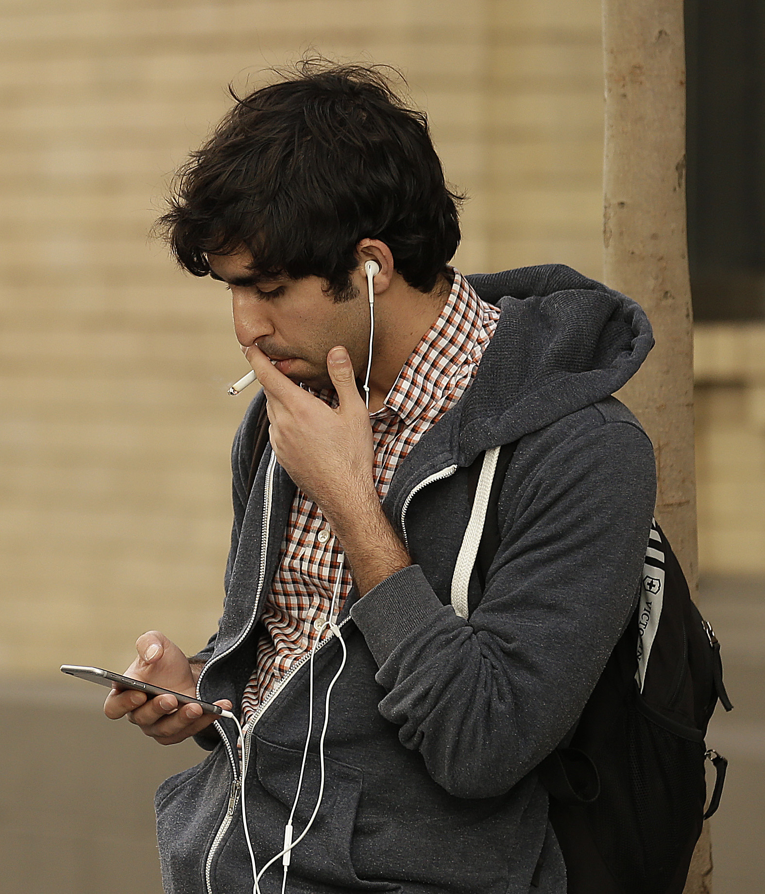 A man smokes a cigarette Tuesday, March 1, 2016, in San Francisco. Officials will vote Tuesday on whether to increase the minimum age to buy tobacco from 18 to 21 in San Francisco, even as opponents argue that cities and counties cannot trump California law. If the measure is approved, San Francisco would join Boston, New York City and Hawaii in raising the minimum age to buy cigarettes and other tobacco products. (AP Photo/Ben Margot) (AP)