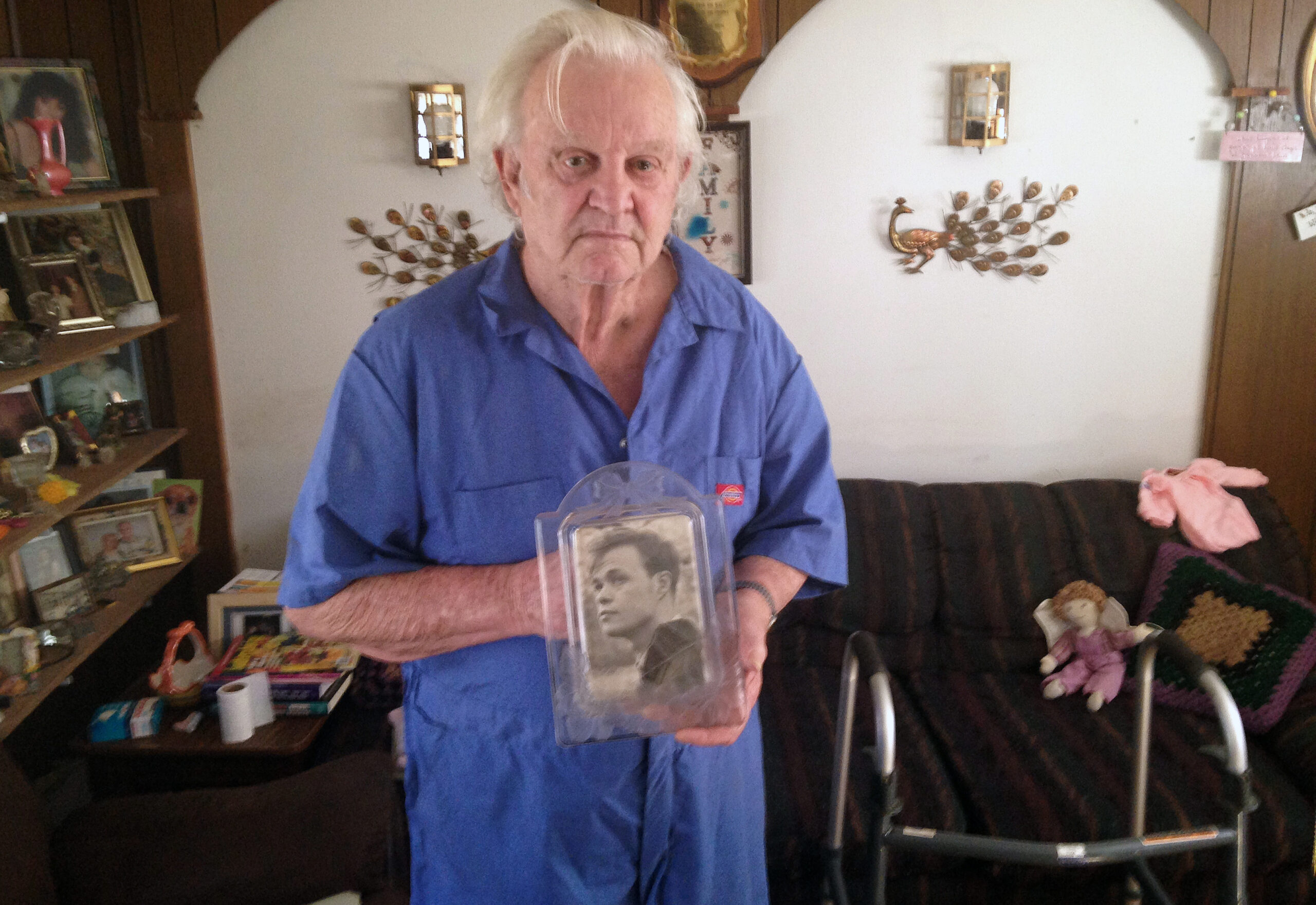 In this undated photo, Donald Burke, of Pollock, La., holds an old photograph of his brother-in-law, Charles Lee Johnson, who died in May 2013 following an altercation with a nursing assistant at a Department of Veterans Affairs medical center in nearby Pineville. Johnson, an Air Force veteran, was 70 years old when he died. VA officials concluded that Johnson died in an accidental fall, but local prosecutors filed a manslaughter charge against the nursing assistant, Fredrick Kevin Harris. His trial, currently set for March 7, 2016, is expected to be postponed. (AP Photo/Michael Kunzelman) (AP)