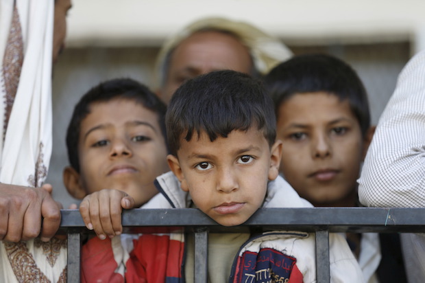 Children wait to receive food vouchers at a food distribution center for poor families in Yemen's capital Sanaa on March 17, 2016 (Reuters/Khaled Abdullah)