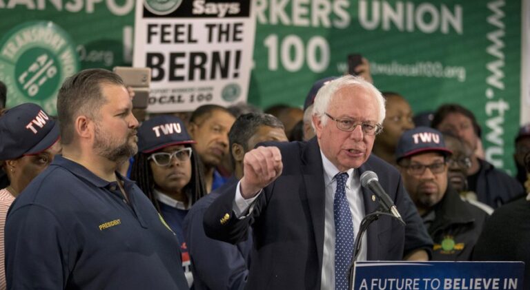 TWU Local 100 President John Samuelsen listens at left as Democratic presidential candidate, Sen. Bernie Sanders, I-Vt. speaks after being endorsed by TWU Local 100, Wednesday, April 13, 2016, in the Brooklyn borough of New York. (AP Photo/Mary Altaffer)