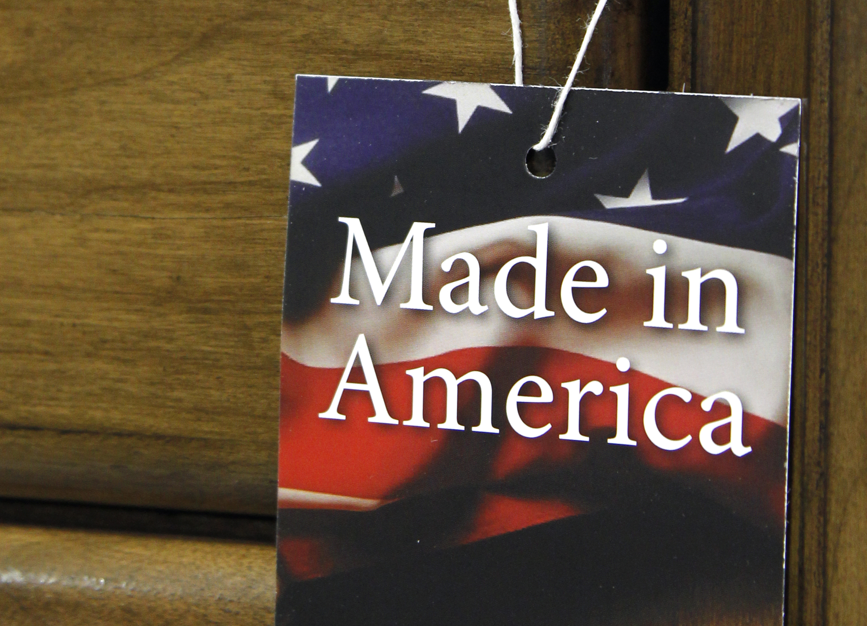 In this March 16, 2012 file photo, a "Made in America" tag hangs on a chest of drawers at a furniture factory in Lincolnton, N.C. The vast majority of Americans say they prefer lower prices instead of paying a premium for items labeled Made in the U.S.A., even if it means those cheaper items are made abroad, according to an Associated Press-GfK poll.  () (AP Photo/Bob Leverone, File)
