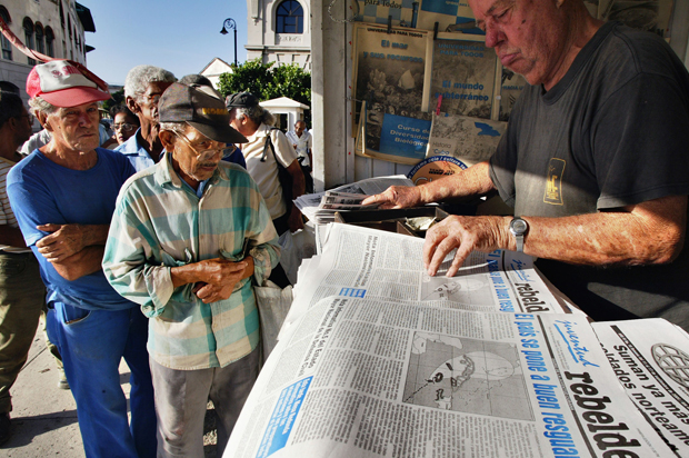 Cubans stand in line in Havana, Cuba, to buy newspapers, Sept. 11, 2004. (AP/Jose Goitia)