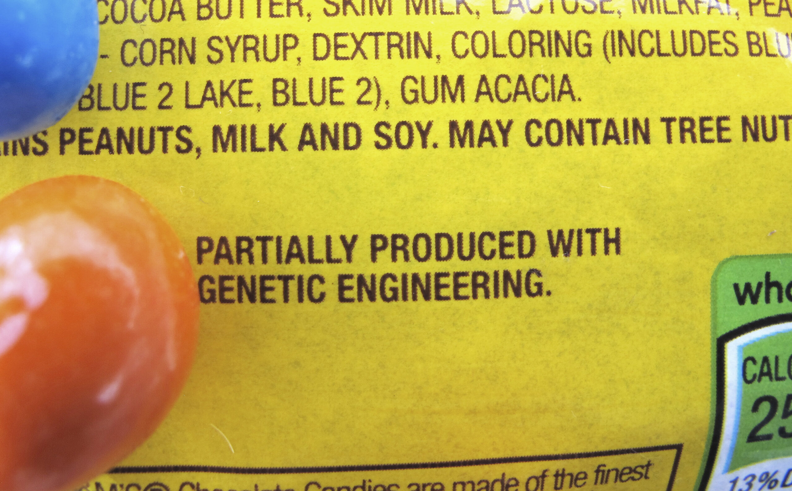In this April 8, 2016 photo, a new disclosure statement is displayed on a package of Peanut M&M�s candy in Montpelier, Vt., saying they are "Partially produced with genetic engineering." (AP Photo/Lisa Rathke)