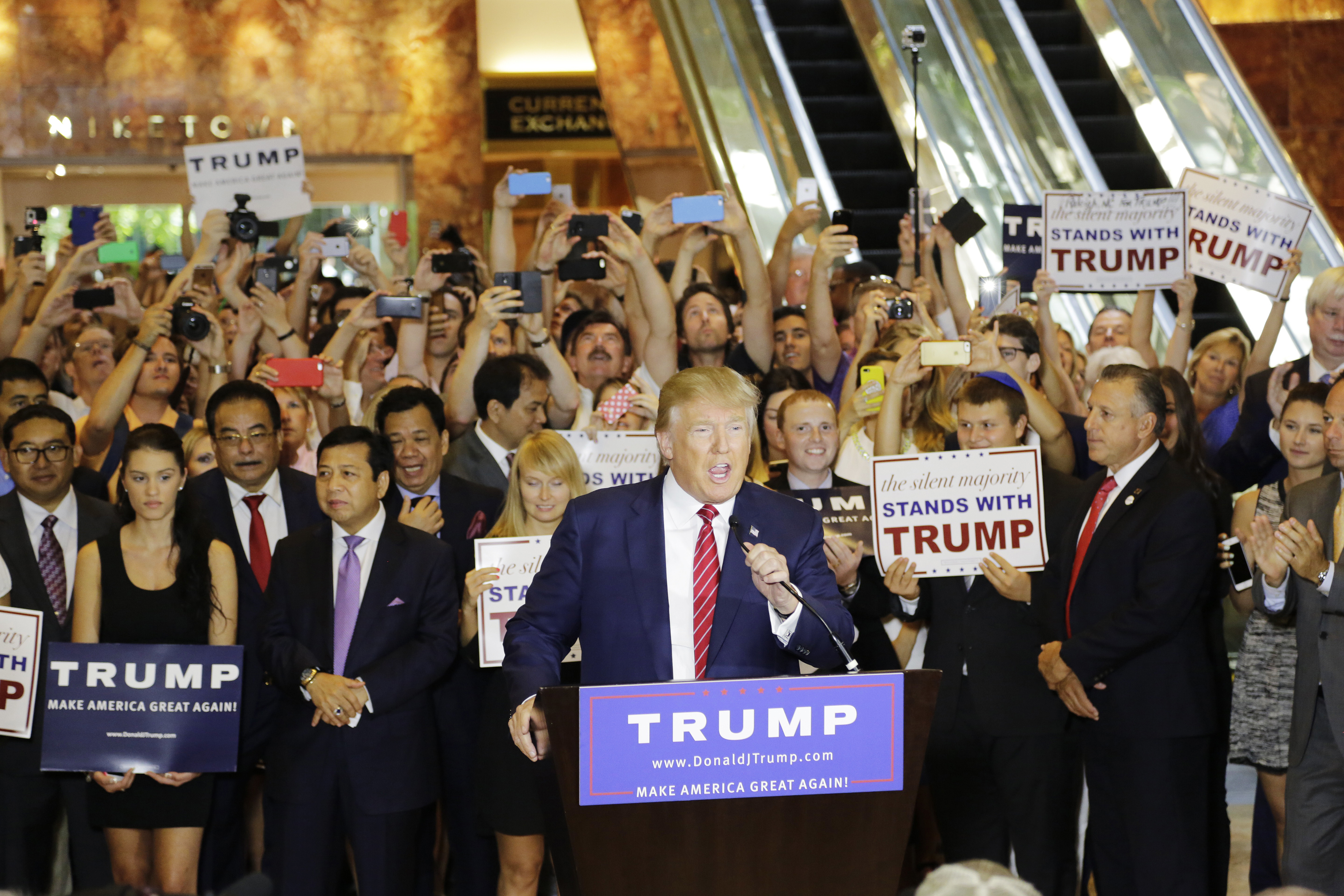 FILE - In this Sept. 3, 2015 file photo, Republican presidential candidate Donald Trump holds a news conference in the lobby of Trump Tower in New York. Days before New York's presidential primaries, the 58-story tower in midtown Manhattan is a cross-section of the world, alive with chatter about the Republican front-runner. People mill around the massive marble entrance floors, sprinkled with boutiques and eateries all bearing his gold-lettered name. (AP Photo/Mark Lennihan, File) (AP)