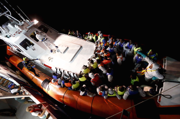 Refugees and migrants in an Italian Coast Guard vessel after traveling between Libya and the Italian island of Lampedusa, on August 3, 2015 (Reuters/Darrin Zammit Lupi)