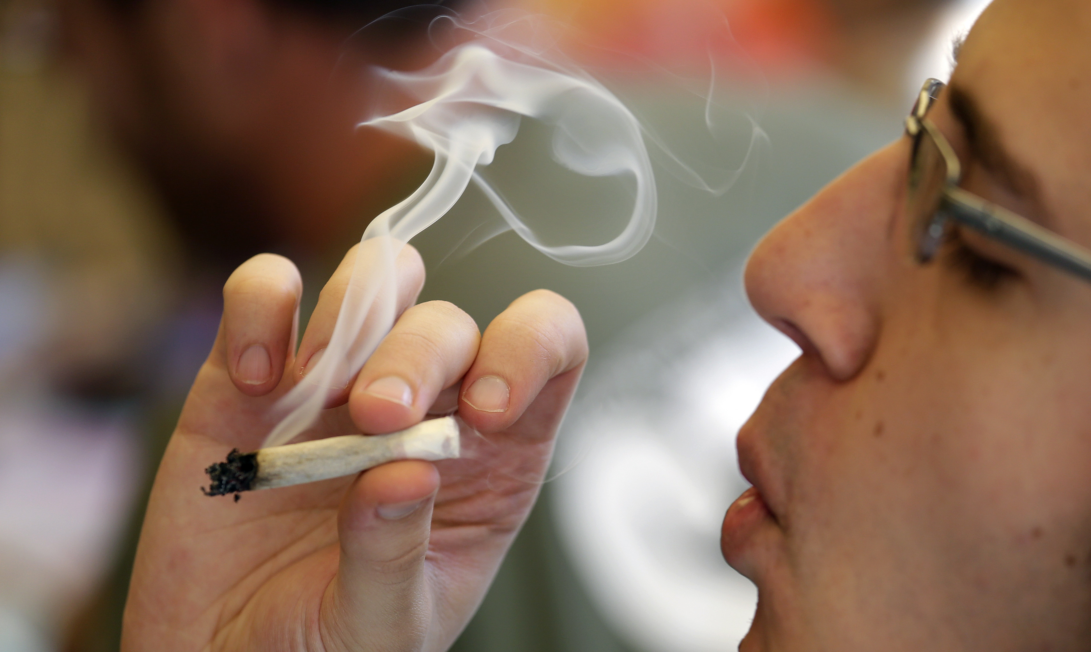 A man smokes a marijuana joint at a party celebrating weed Wednesday, April 20, 2016, in Seattle. Fans of the drug have long marked April 20 as a day to roll weed or munch on pot-laced brownies, and call for increased legal access to it. This year's celebrations throughout the U.S. come amid loosening of marijuana restrictions and increasing tolerance for the plant's use from Alaska to Massachusetts. (AP Photo/Elaine Thompson) (AP Photo/Elaine Thompson)