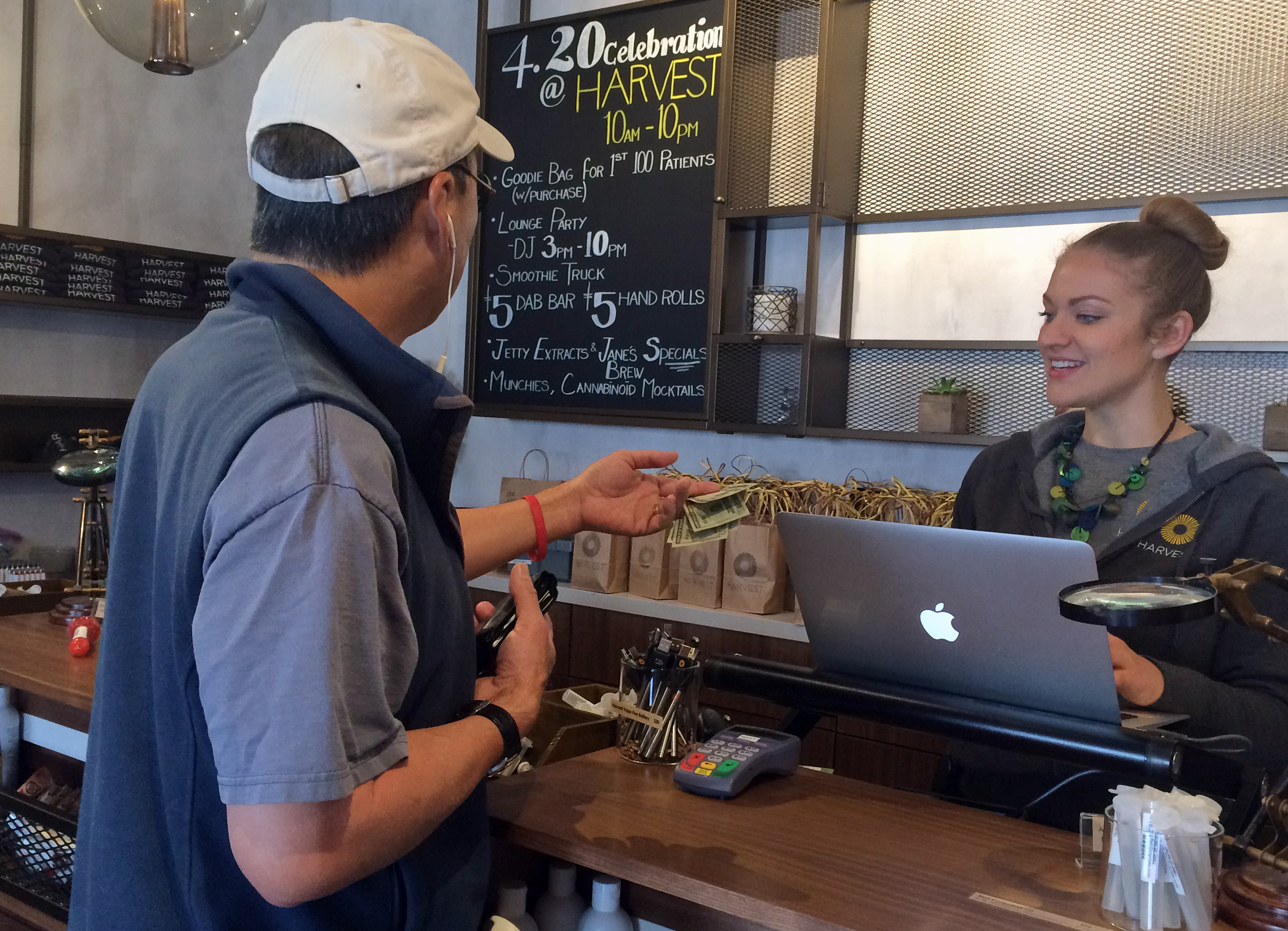 Gannon Castner, right, helps a customer at the Harvest Medical Marijuana Dispensary in San Francisco, Wednesday, April 20, 2016. (AP Photo/Haven Daley)