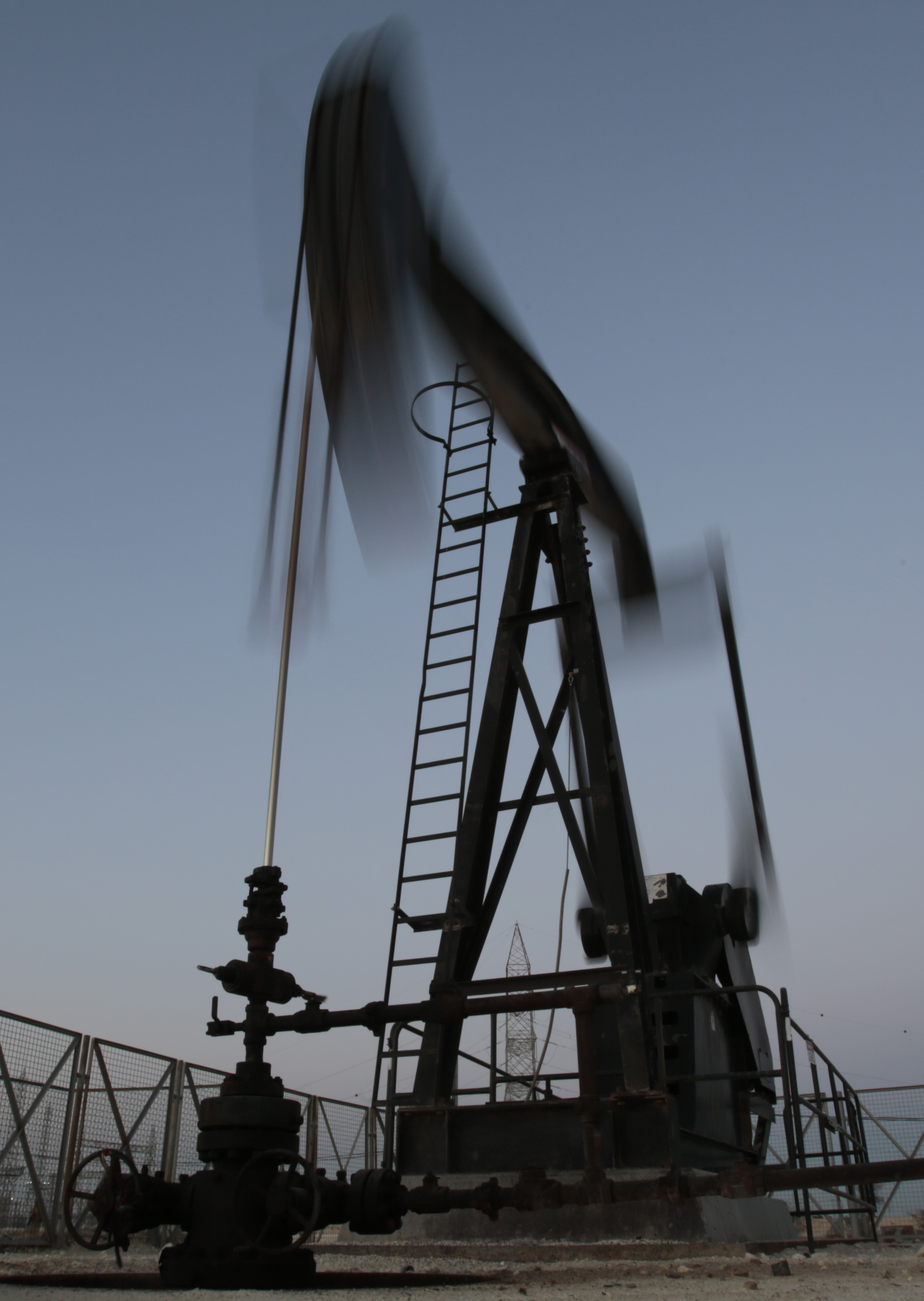 An oil pump works, on Saturday, April 16, 2016, in the desert oil fields of Sakhir, Bahrain. Oil-producing countries are to meet in Qatar on Sunday, April 17, 2016, to discuss a plan to freeze output but their gathering comes as nations like Iran rapidly ramp up their pumping. (AP Photo/Hasan Jamali) (AP)